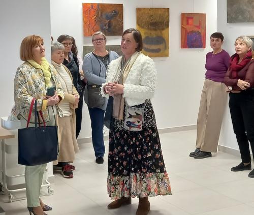 7 uczestnicy wernisażu wystawy Anny Siek słuchają Artystki