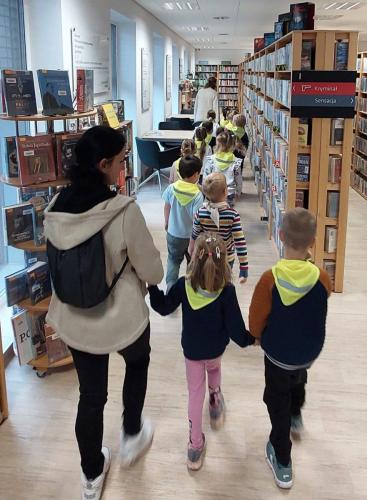 8 ciekawski George dzieci z opiekunką zwiedzają bibliotekę